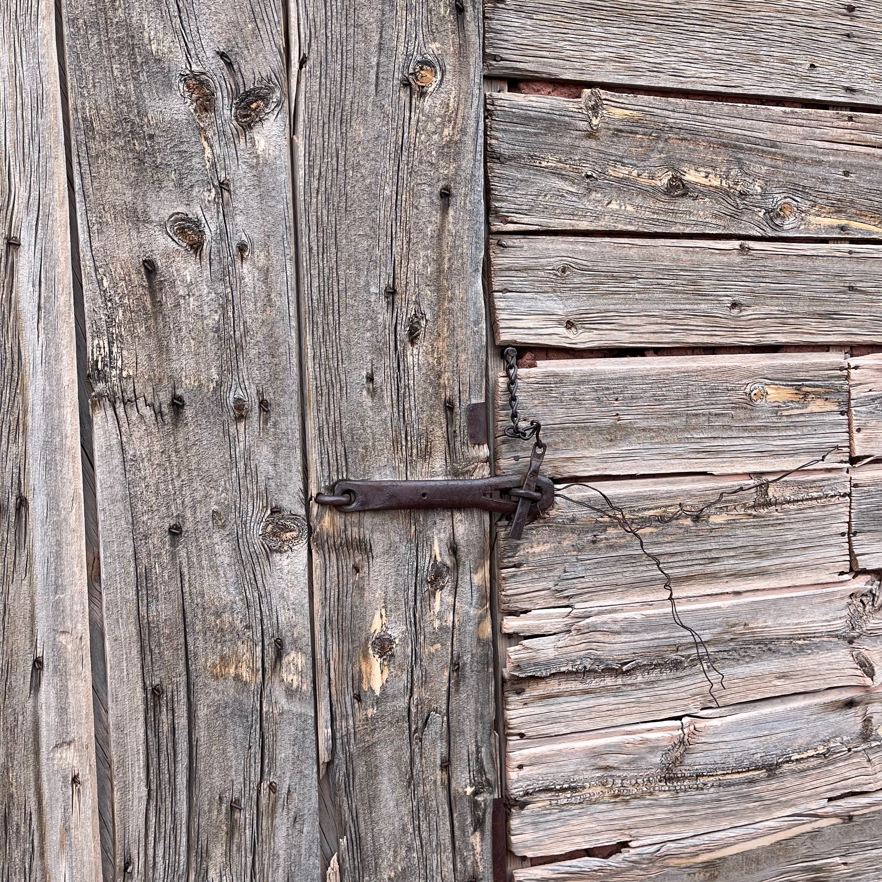 Iron latch on aged wooden gate