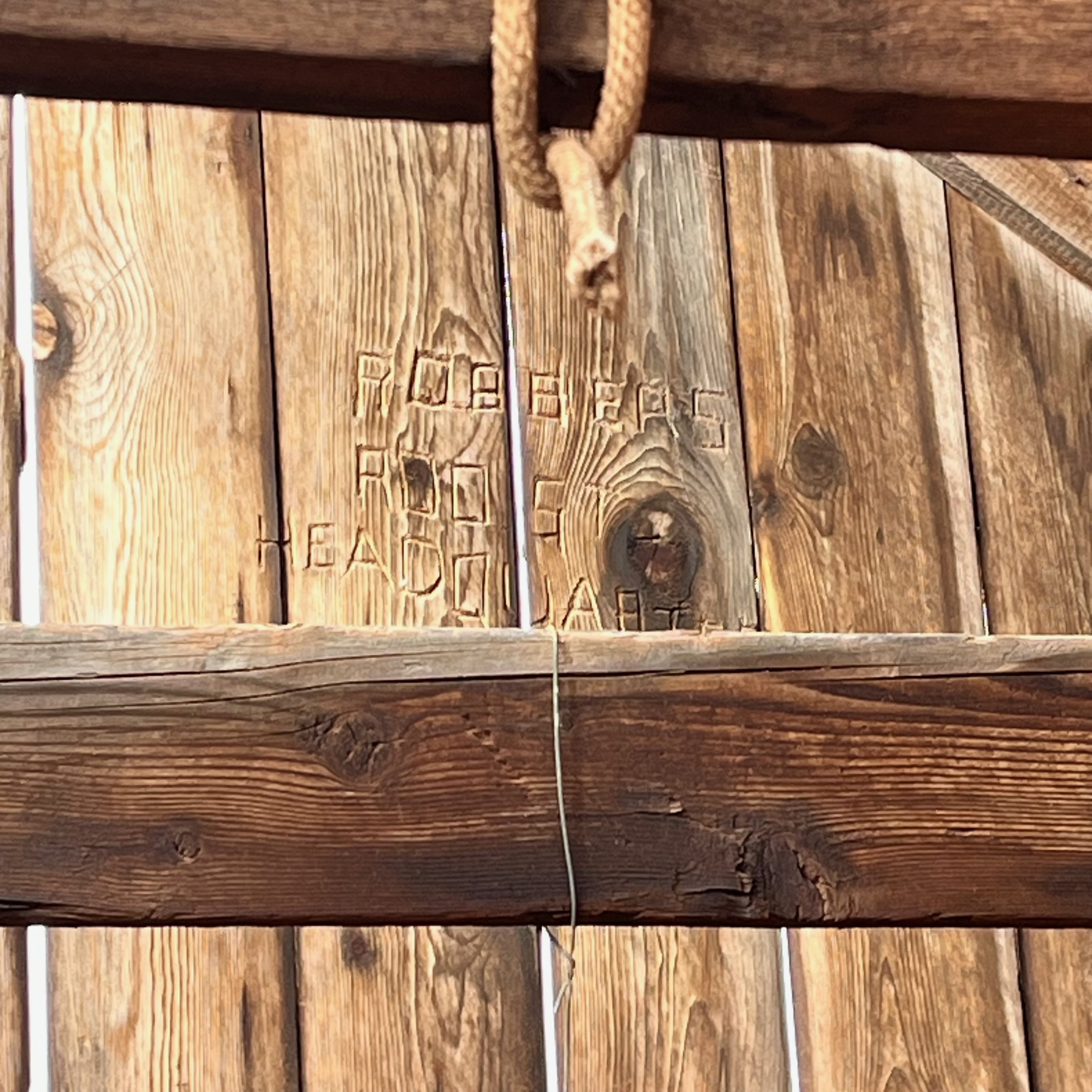 Hand-carved inscription on wooden fence